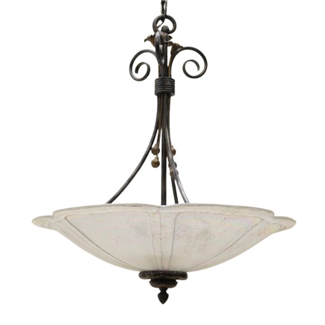 Large, iridescent glass in a flower pedal form holds three light sockets and has a distinctive white splatter pattern....