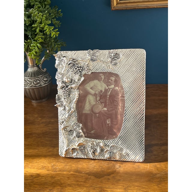 An exquisite Italian handcrafted 925 silver picture frame, richly detailed with a sculptural grapevine and leaf motif,...