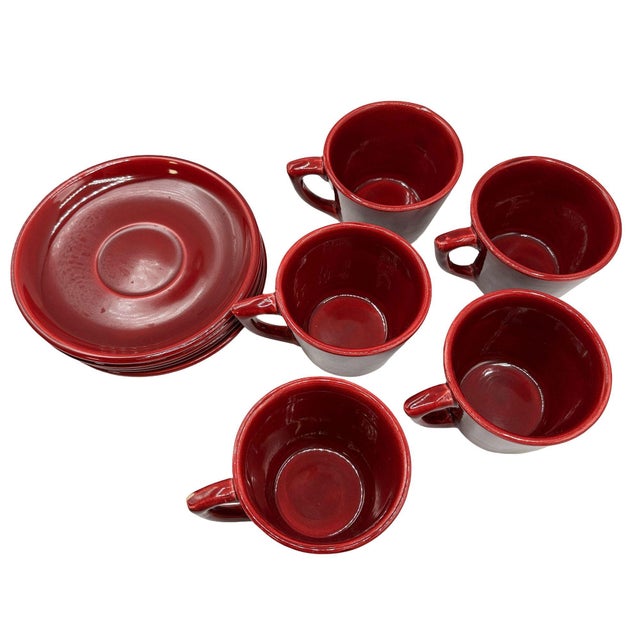 Set of five mid-century “La Linda” ceramic mugs with five matching saucers by Bauer, finished in a rich glossy burgundy...