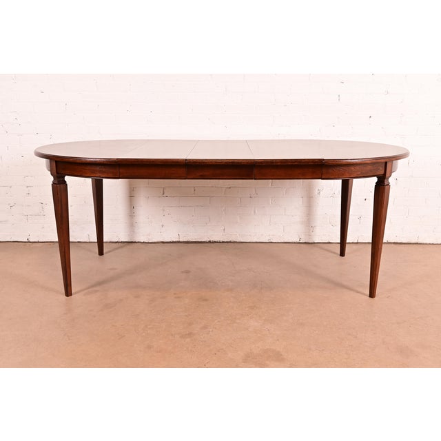 An exceptional French Regency Louis XVI style carved walnut extension dining table In the manner of Henredon USA, Circa...