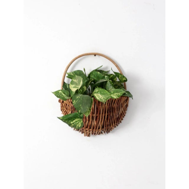 This is a vintage woven basket. It rustic twig basket features a flat back for smooth hanging on the wall from its...