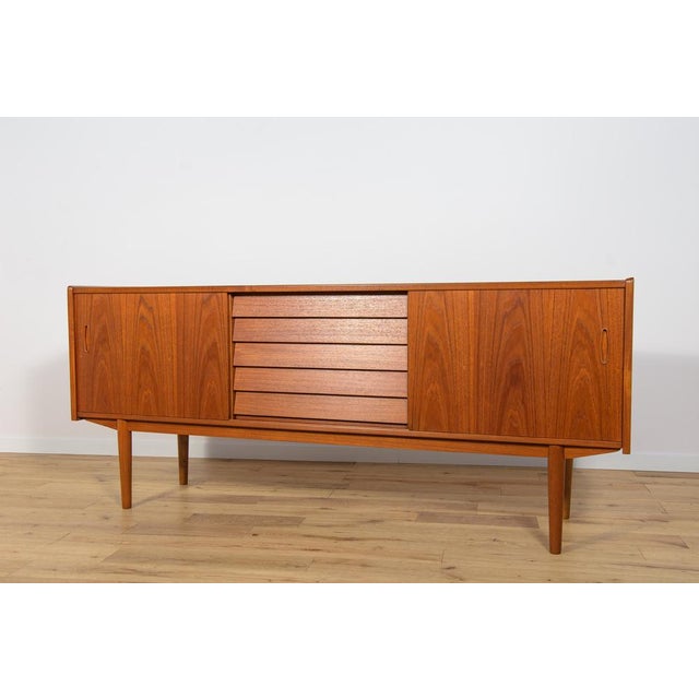 This mid-century Swedish sideboard was designed by Nils Jonsson and manufactured by Hugo Troeds from Sweden. It is made of...