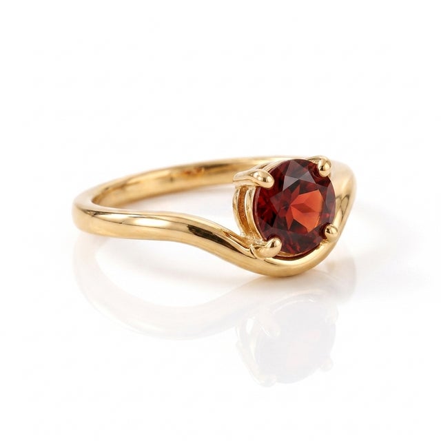 Capture dramatic romance with the intense, crimson glow of natural red garnet. The smooth, sweeping band curves under the...