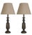 An elegant pair of American Mid-Century brass table lamps from the 1950s, distinguished by their sculptural turned forms...