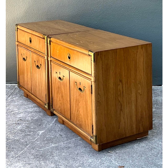 This handsome pair of campaign-style nightstands by the esteemed American maker Drexel seamlessly blends military-inspired...