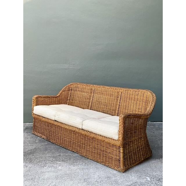 This vintage three-seat sofa is a stunning example of mid-century coastal craftsmanship, featuring an expertly hand-woven...