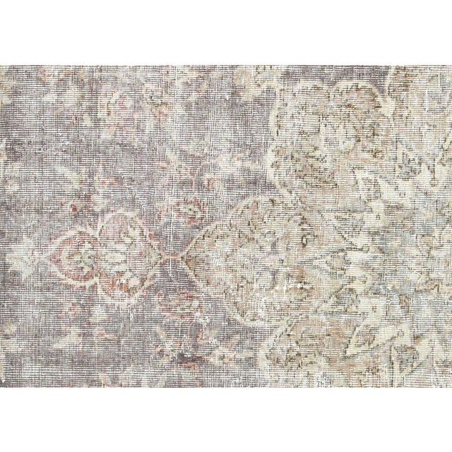 This vintage Oushak rug from Western Turkey measures 6'7" x 10'3" and features hand-woven wool construction. With its bold...