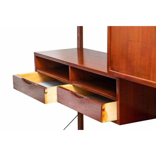 Vintage bookshelf "cado" is an original design item realized by Paul Cadovius, Denmark, in 1960s. Wall unit in teak...