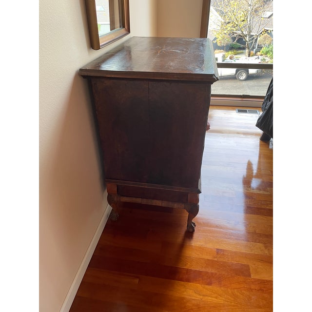 Beautiful burled walnut veneers with compass rose inlays. We've always used it as a liquor cabinet and it serves admirably...