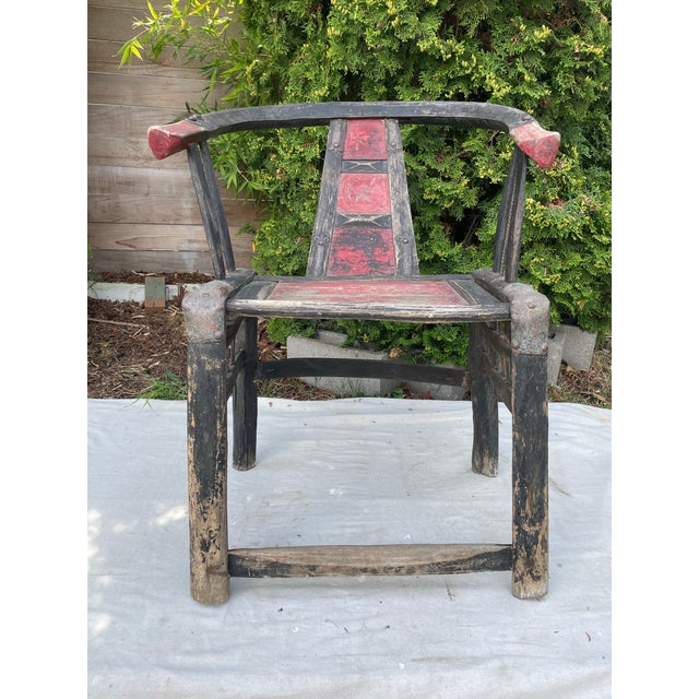A primitive 19th century elm horseshoe back armchair. This classical Chinese armchair has good proportions and a nice...