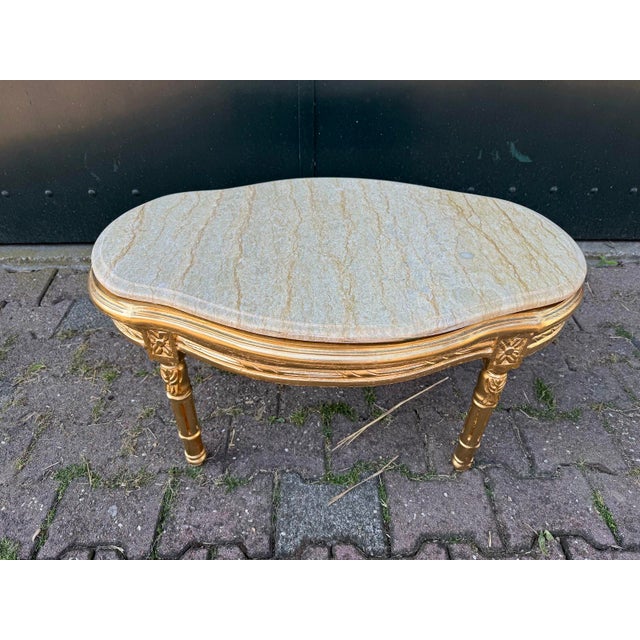 A refined vintage French Louis XVI style table dating from around 1950, beautifully crafted with a carved beechwood frame...