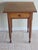 This is a 19th century single drawer federal style table. It is constructed of solid cherry and accented by a stunning...