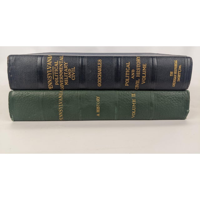 The green volume is Pennsylvania: A History, Volume II, dating to 1926. The dark navy volume is Frederic A. Godcharles'...