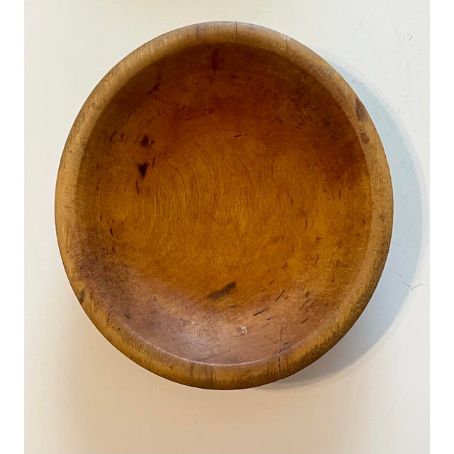 Pair of 19th century wooden farmhouse bowls with natural aged patina. The red paint bowl measures about 8 1/4” x 7 3/4” x...