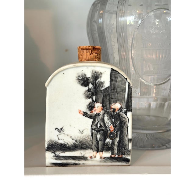 This is a flat-sided, arched-top ceramic snuff bottle—a popular collectible form that originated during the Qing Dynasty....