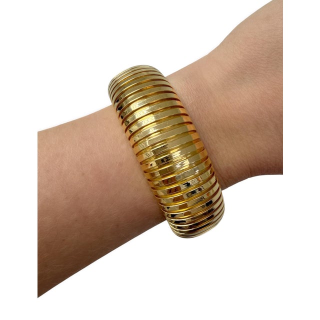 This classic quintessential bracelet by Sidney Garber is designed as a flexible tubogas domed cuff. Skillfully crafted out...