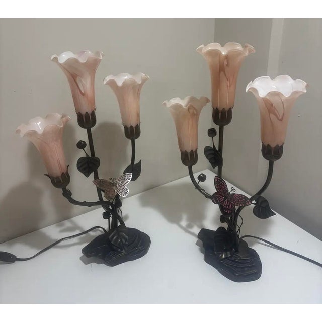 This pair of Dale Tiffany 3 Light Bronze Tulip butterfly Table Lamps are vintage-inspired stained glass lamps with a...