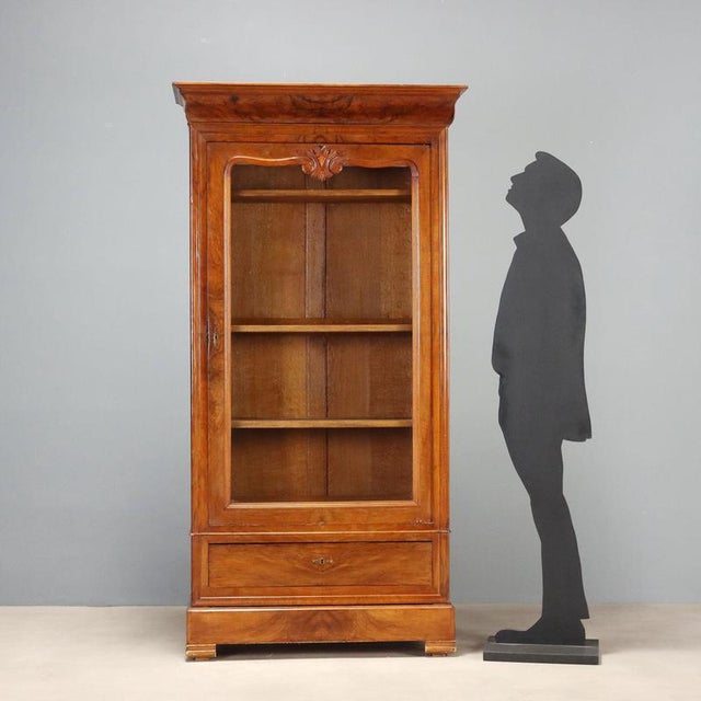 Louis Philippe wardrobe in walnut, crafted in France in the second quarter of the 19th century, featuring a refined glass...