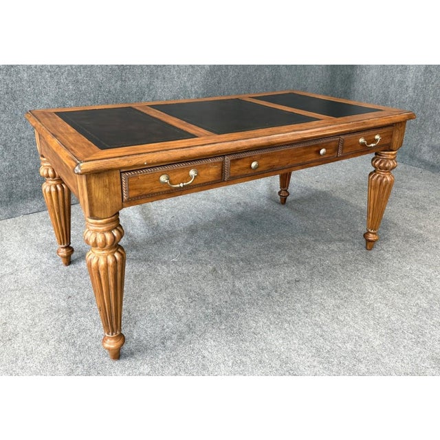 This Hooker Seven Seas Collection executive desk features a classic, refined design with a warm wood finish, fluted legs,...