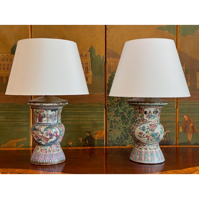 A near pair of 19th C. Chinese export baluster form vases fashioned into lamps, painted in pinks, greens and blues. One...