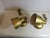 Pair of gold-painted aluminum wall lamps. Featuring a highly functional joint in the arm that allows the lamps to be...