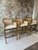 Elevate your kitchen island or home bar with this stylish set of three bar stools featuring classic cane backs, wood...