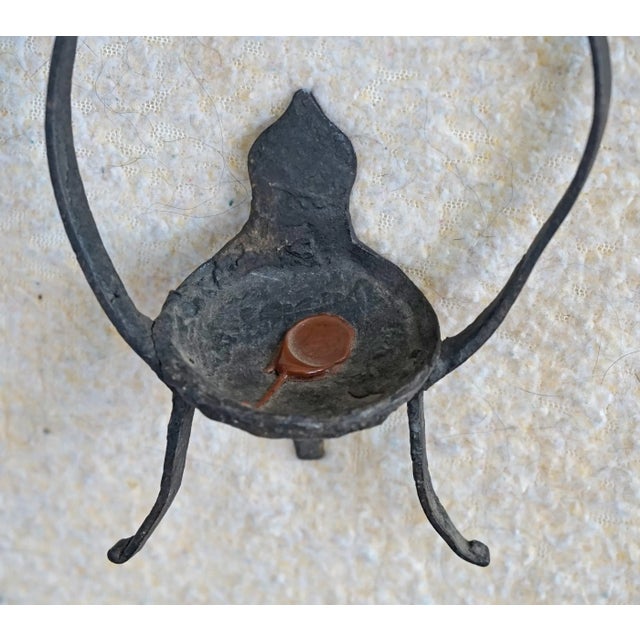 This antique iron mutton fat candle holder was sourced from a peasants home in Shanxi province China...Using a mutton fat...