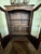 Beautiful wood sheen with French carvings and glass doors for easy display of books, china or other collectibles.
