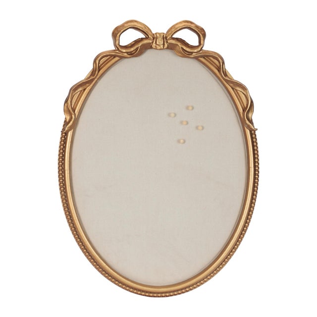 Add both function and charm to your space with this decorative pin board frame, featuring an elegant oval shape accented...