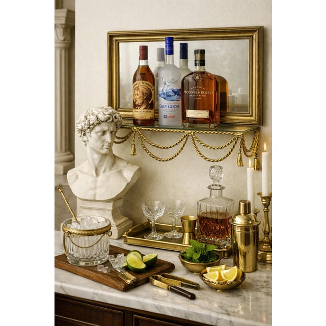 A beautifully crafted solid brass tassel wall shelf with an inset glass top, featuring rope‑and‑swag detailing and classic...