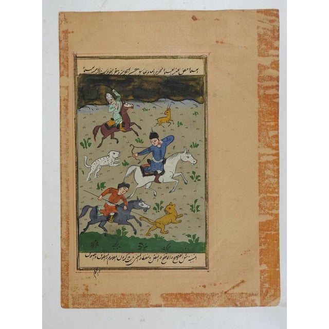 19th century gouache on paper Persian miniature hunting painting on illuminated book page. Lion, leopard, antelope, horses...