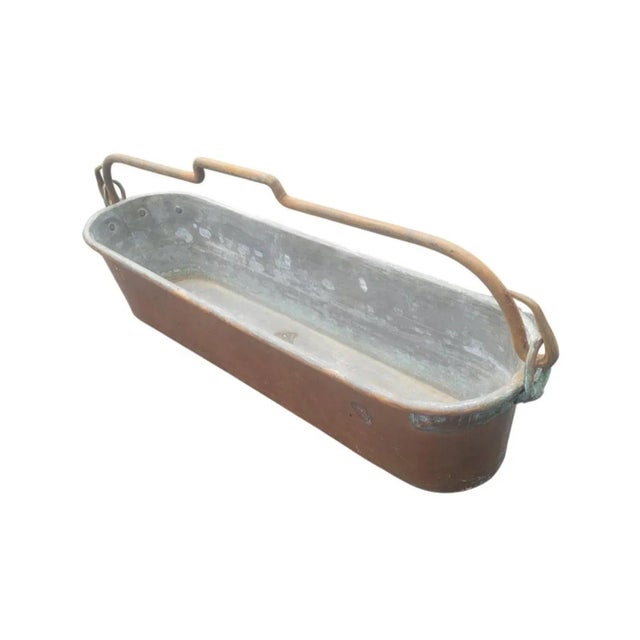 Early 20th century French Hammered Copper Lateral Jardiniere Planter with forged iron handle. This heavy duty jardiniere...