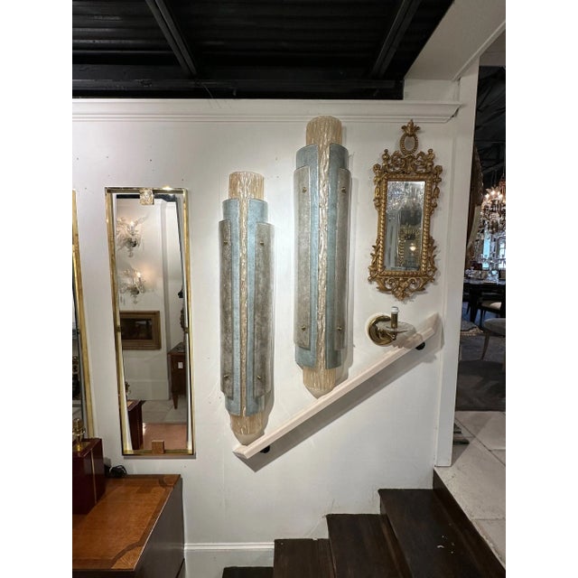 Very fine pair of large scale modern layered Murano glass sconces. Beautiful colors of silver, gold and champagne colored...