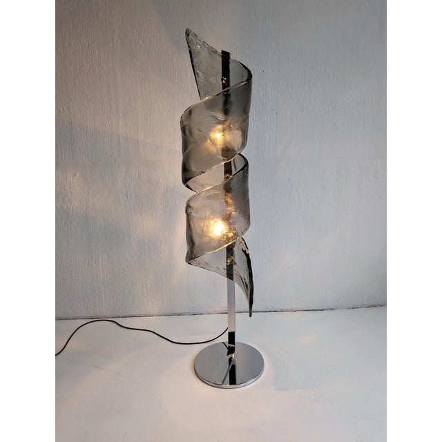 Vintage Space Age floor lamp from 1970s Italy, with a chrome base and a dark grey, murano glass spiral top. The lamp has a...