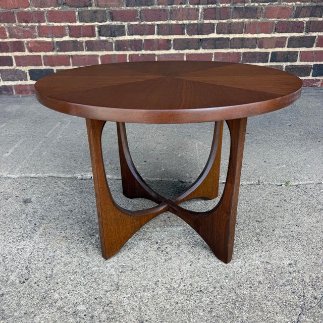 Beautiful vintage Broyhill Brasilia round side table featuring a distinctive sculptural base and stunning radial wood...