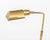 Modern Brass Adjustable Floor Lamp, with articulated light on rectangular base. 45.75" H x 17.5" W x 6.25" D. Provenance:...