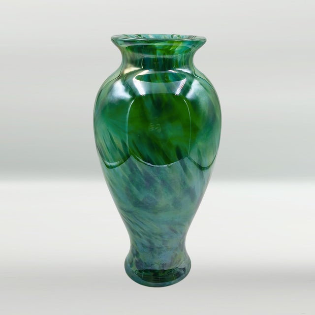 This vase is crafted on the legendary island of Murano, Italy, during the 1960s, this exquisite blown glass vase stands an...