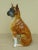 This is a large glazed Italian terra cotta model of a sitting boxer dog. The piece is from the 1970s.