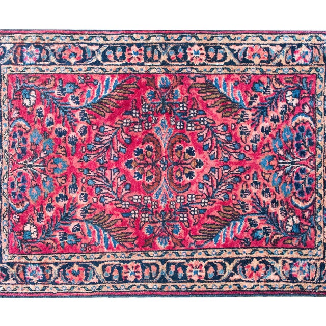 This early 20th-century Persian Lilihan rug features a beautifully mirrored floral design, where sweeping leafy branches...