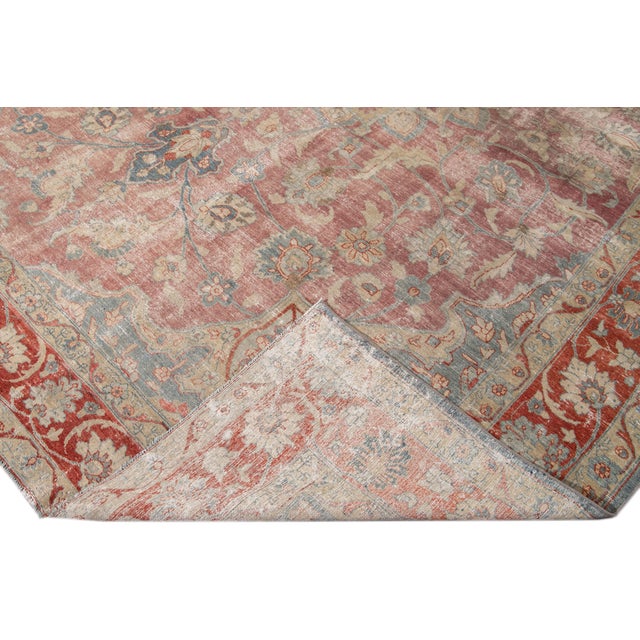 Beautiful antique Persian Tabriz hand-knotted wool rug with a red and blue field. This Tabriz has a rusted frame and...