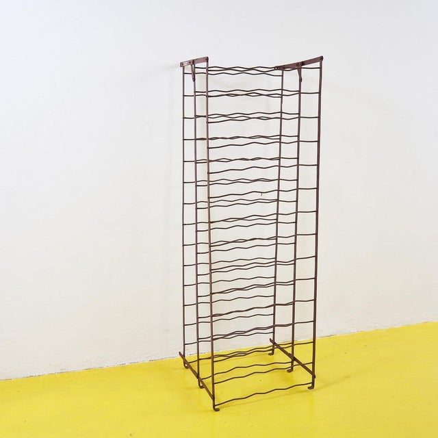 This elegant metal bottle holder is a charming piece of 1960s design, crafted with a slender, wavy structure that combines...