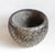 Hand carved solid black marble bowl with repeating woven geometric design. Opening at top measures 19" diameter. No...
