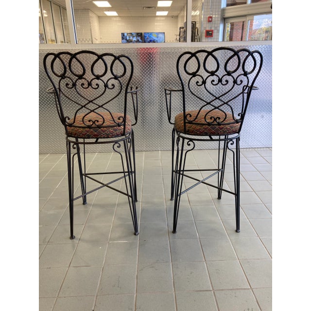 A very fine and well preserved set of late 20th century Ethan Allen wrought iron bar height counter stools with...