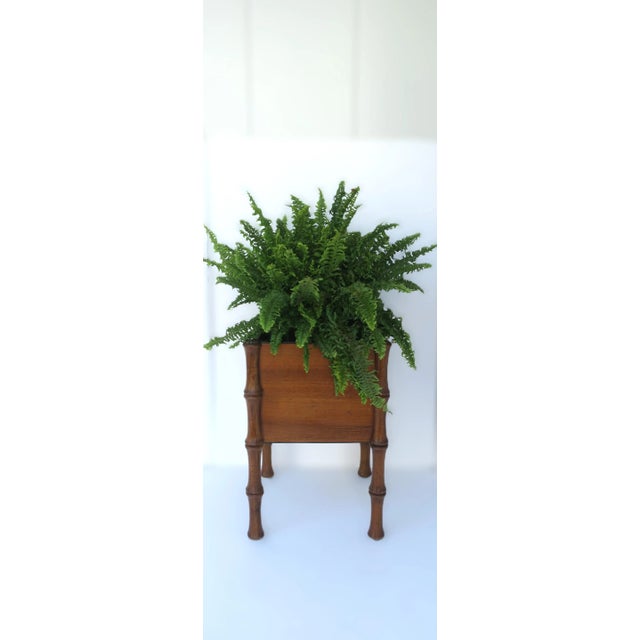 An Italian wood cachepot plant stand, circa mid-20th century, Italy. Piece has a square pot/plant cachepot area with...