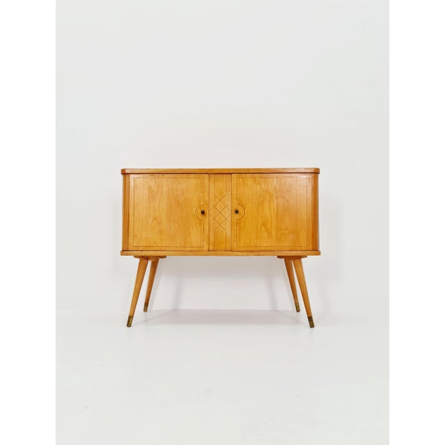 German mid-century ash and beech small sideboard/side table, 1950s. Dimensions: 33 D x 75 W x 59 H cm. It is in good...