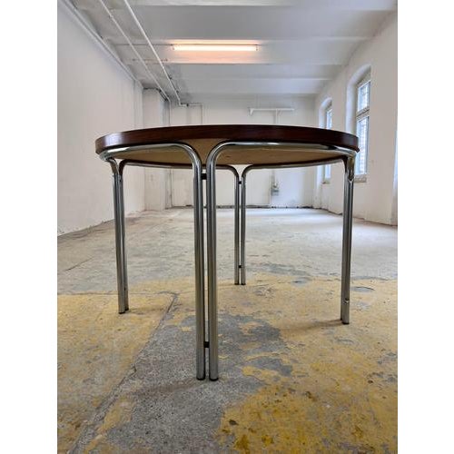 This round dining table is an exquisite design object that perfectly blends mid-century elegance with the futuristic flair...