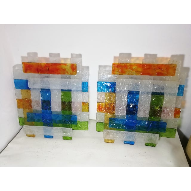 Pair of large wall lamps. Designed by Albano Poli for Poliarte. The colors of the original glass are beautiful and unlike...