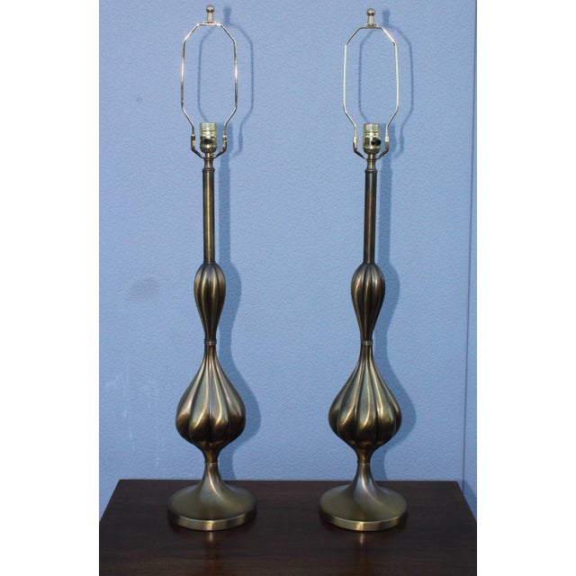 1950s patinated brass tall table lamps by Stiffel. Height to light socket 31.5.
