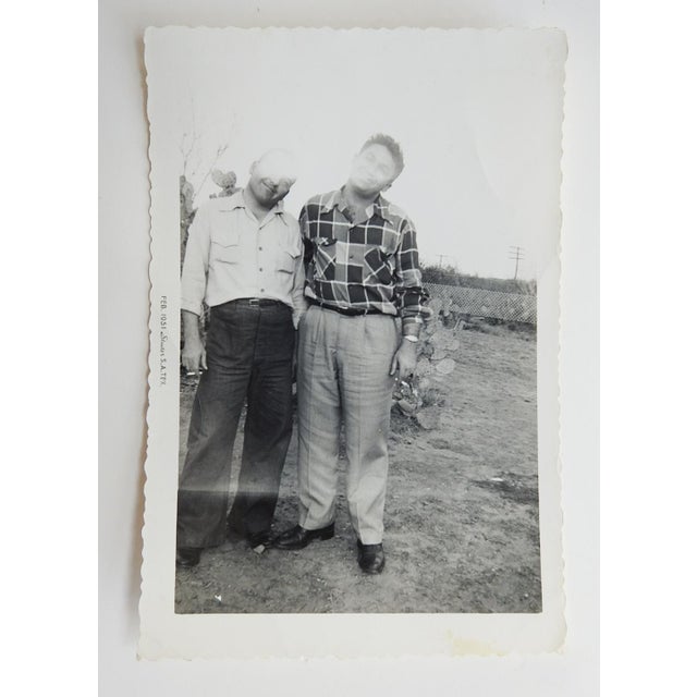 1951 snapshot photograph of a couple silly men with heads in the clouds (an overexposure). Unframed.