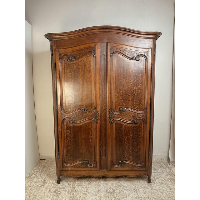 Handcrafted from solid French oak around 1900, this handsome French Provincial armoire embodies the timeless craftsmanship...